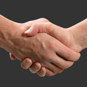 Two hands clasped in a handshake before a dark background