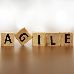 Scrabble tiles spell out "Agile"