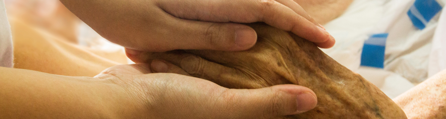 close up of young and old hands clasped in support